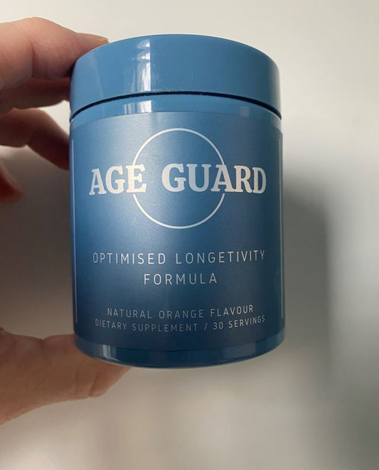 Smiling woman in kitchen holding with fresh greens and water for healthy living