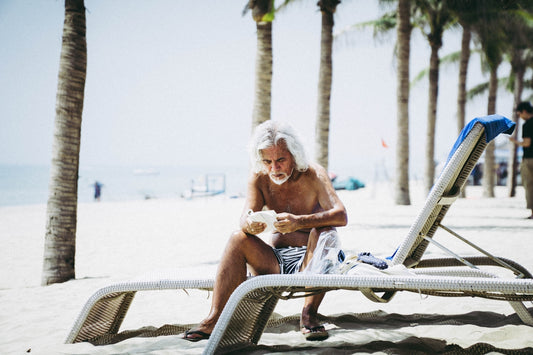 man sitting on white chaise lounge