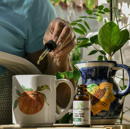 person pouring tea on white ceramic mug