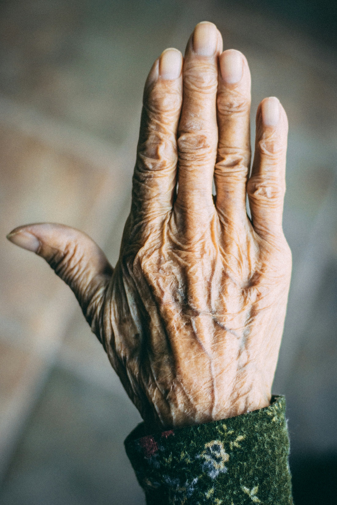 an old woman's hand with a wrist band