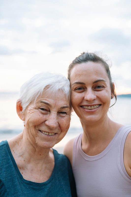 Longevity Challenges - two women standing next to each other on a beach