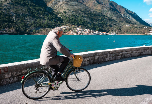 a man riding a bike next to a body of water