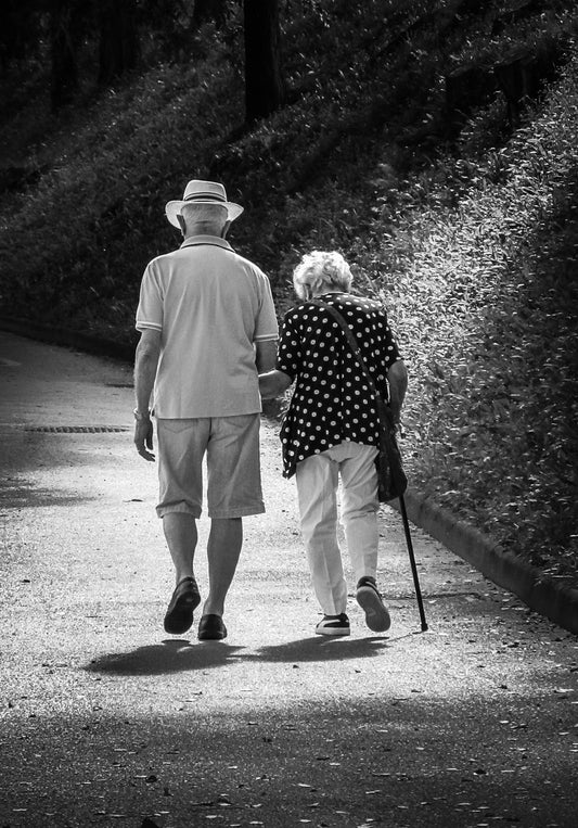 A man and a woman walking down a path