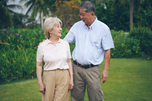 Elderly couple walking together in a park